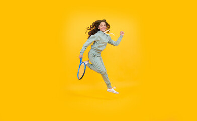 Fototapeta na wymiar energetic child with tennis racquet. teen girl run to training. dedicated to fitness
