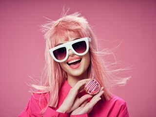 cheerful woman glamor fashion glasses pink background sweets