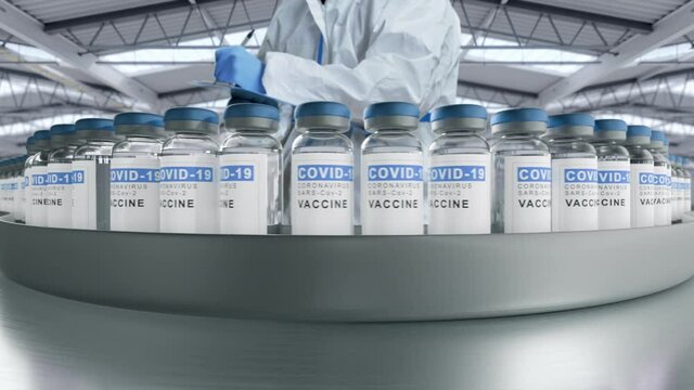 Covid-19 vaccine manufacturing,bottles vials passing on conveyor belt,worker taking notes checking the batch,pharmaceutical  company production line  factory