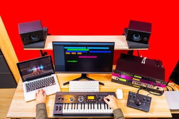 top view of professional music producer hands arranging a hit song in home recording studio. music...