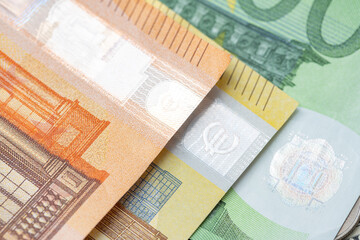 Colorful Euro Banknote, Orange fifty Euro, Yellow 200 Euro and green one hundred Euro bills. Closeup of Euro Bills. Hologram reflecting Light