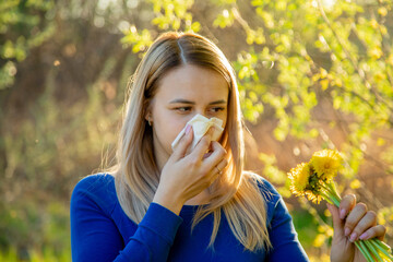 The girl is allergic to flowers in the field. Selective focus