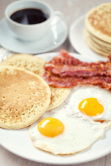 Fried Eggs with Pancakes and Bacon. High quality photo.