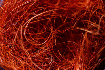 Thin bright red threads in chaotic motion close-up, macro, abstract texture background.
