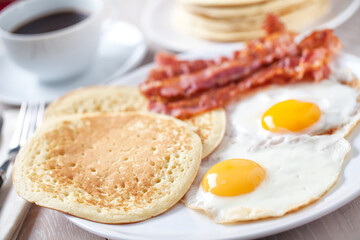 Fried Eggs with Pancakes and Bacon. High quality photo.