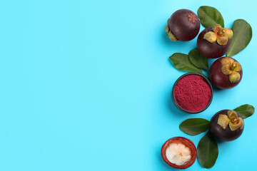 Purple mangosteen powder and fruits on light blue background, flat lay. Space for text