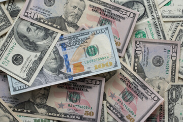 Fototapeta na wymiar Dollar banknotes spread out. One dollar to one hundred dollar banknotes. Background with US dollar banknotes. Cash 100 and fifty dollar bills