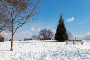 Rainey Park in Astoria Queens New York Covered in Snow during Winter with a Hill and Bench
