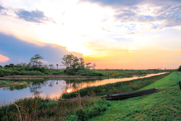 Fototapeta na wymiar sunset in the swamp refecting in the river