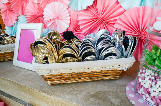 Comfortable slippers folded to give to the guests in a basket on a party decorated table.