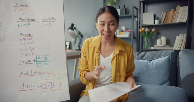 Young Asia lady teacher video conference looking at camera talk by webcam learn teach in online chat at home. Remote school classroom, Social distancing, quarantine for corona virus prevention.