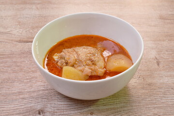 chicken curry with slice potato and onion in bowl