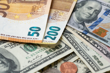 Fototapeta na wymiar 200 Euro banknote next to 50 euros on top of one hundred dollar bills. Trading Euro with Dollar.