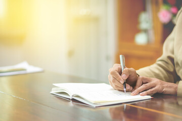 Business people take notes with pen on notebook