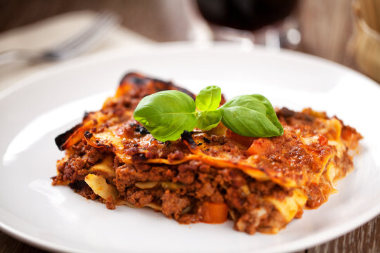 Piece of tasty hot lasagna. Close up, side view. High quality photo.