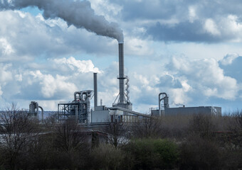 Fototapeta na wymiar smoking chimney of a factory against sky in Germany
