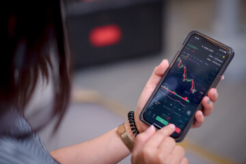 The young model is about to sell shares on her cell phone.