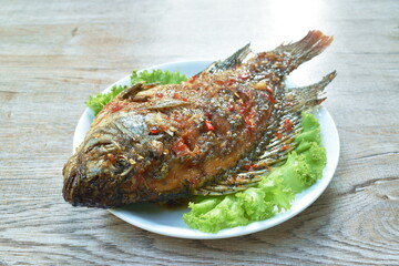 batter fried mango fish dressing spicy and sweet sauce on plate