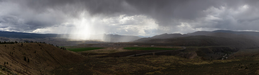 Panoramic View of Desert Mountain Canadian Nature Landscape. Stormy and Rainy Weather. Taken in Savona near Kamloops, British Columbia, Canada. Background Panorama