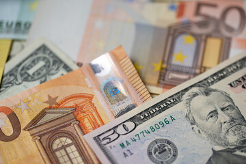 Fifty euro and dollar banknotes, european with american money system concept. Trade between EU and USA.