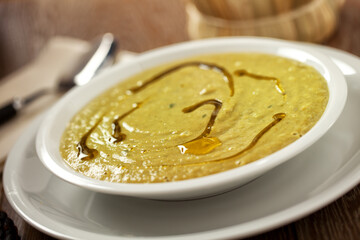 Season Soup with asparagus and vegetables on a plate.