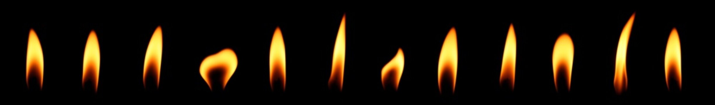 set candle flame is burning At night at close range isolated on black background