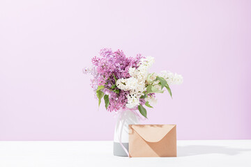 Bouquet white and violet lilac flowers in vase