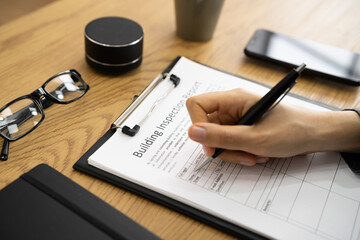 African American Inspector Checking Building Report