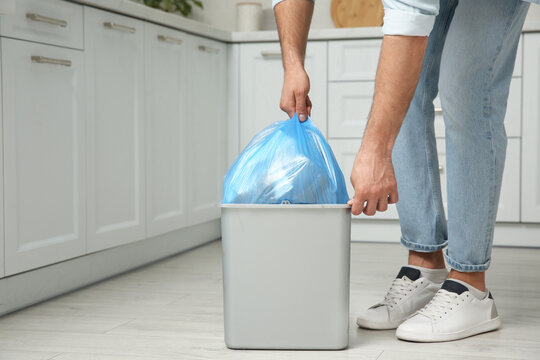 Man Taking Garbage Bag Out Of Bin At Home, Closeup