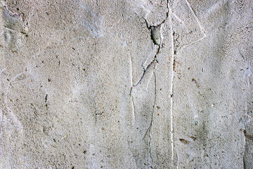 Grunge concrete cement wall with bumps and cracks in industrial building, great for your design and background texture. Copy space.