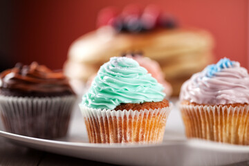 Selection of Colored Cupcakes on a Plate. High quality photo.