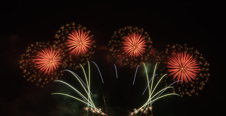 International fireworks festival display at night. Variety of colorful fireworks in holidays celebration isolated on black. Happy New Year Background. © tampatra