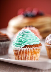 Selection of Colored Cupcakes on a Plate. High quality photo.