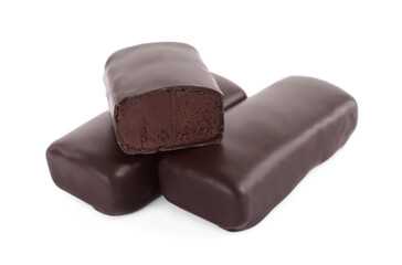 Delicious glazed cut and whole cheeses with cocoa on white background