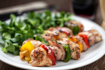 Chicken skewers with side salad. High quality photo.