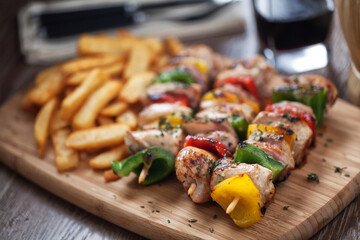 Chicken skewers with fries. High quality photo.