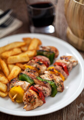 Chicken skewers with fries. High quality photo.