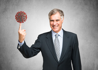 Businessman holding a virus on his finger, covid or coronavirus concept