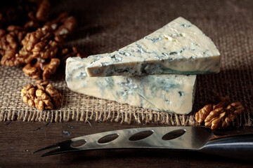 Blue cheese, walnuts, and cheese knife.