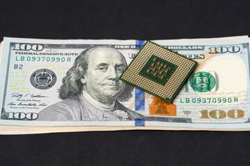 CPU processor on dollar bills. Transistors on central processing unit and pins for connection. Cost of technology concept