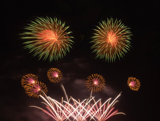 International fireworks festival display at night. Variety of colorful fireworks in holidays celebration isolated on black. Happy New Year Background. © tampatra