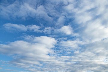 Spindrift clouds. Blue sky with white clouds.