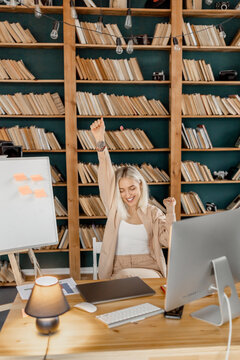 Photo of young smiling positive good mood lovely pretty freelance girl, closing eyes and raising hands, enjoying free time break from work at home office. Distant work concept