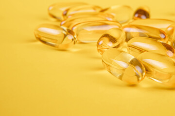 Omega 3 capsules.Vitamin drop pill capsule. Shining golden essence droplet. 
