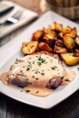 Fillet of beef with potatoes and asparagus on a plate.