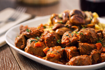 Polenta and beef stew on a plate. High quality photo.