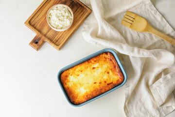 Dish with tasty cottage cheese casserole on light background