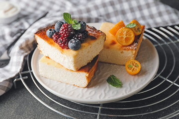 Plate with pieces of cottage cheese casserole on dark background