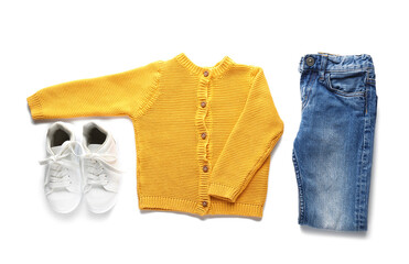 Set of child's clothes and shoes on white background