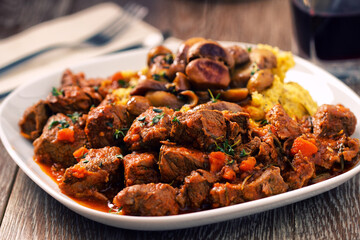 Polenta and beef stew on a plate. High quality photo.